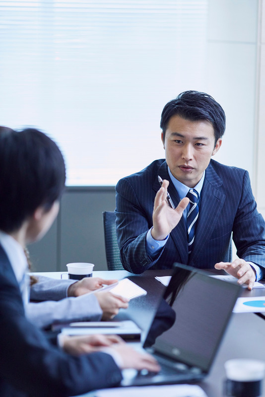 A professional discussing requirements in a business meeting